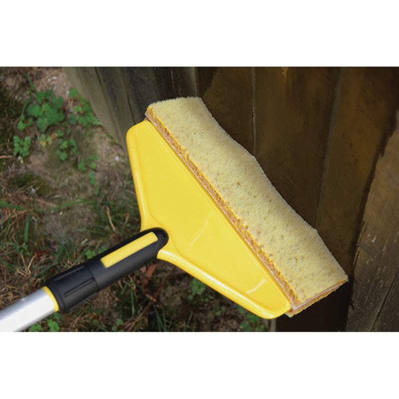 Flex Core Stain Applicator staining a wooden fence