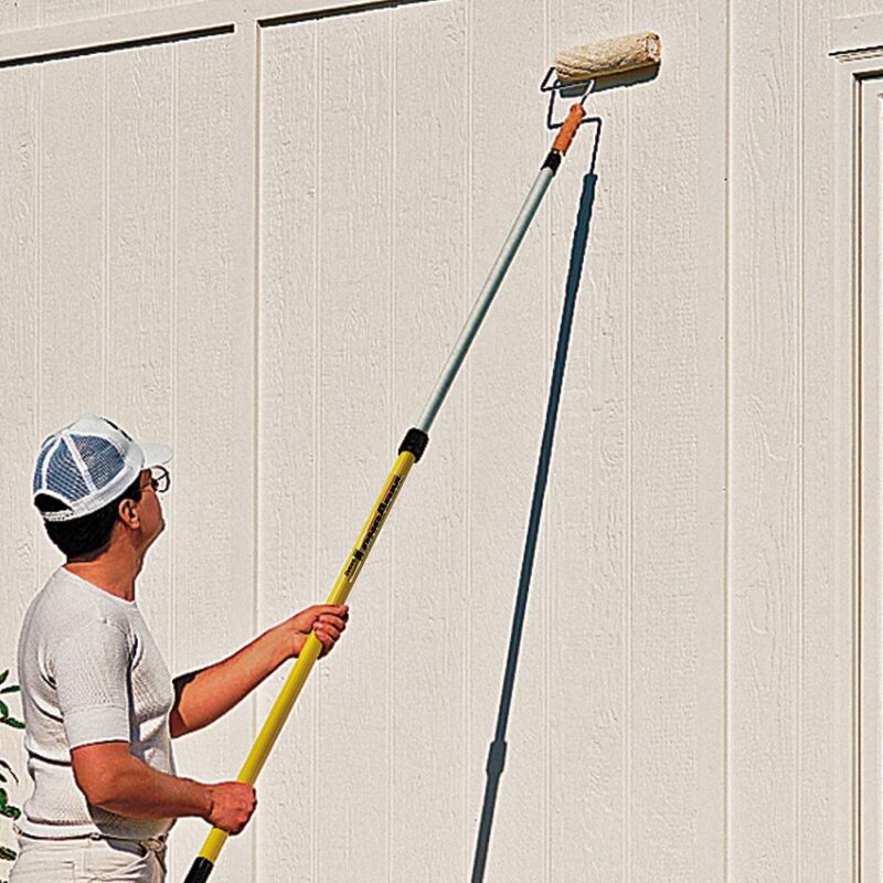 Contractor using a Pro-Lok to paint the siding on a home