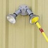 Closeup of Smart floodlight bulb changer changing a floodlight