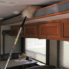 Dusting inside an RV with a lambs wool duster.