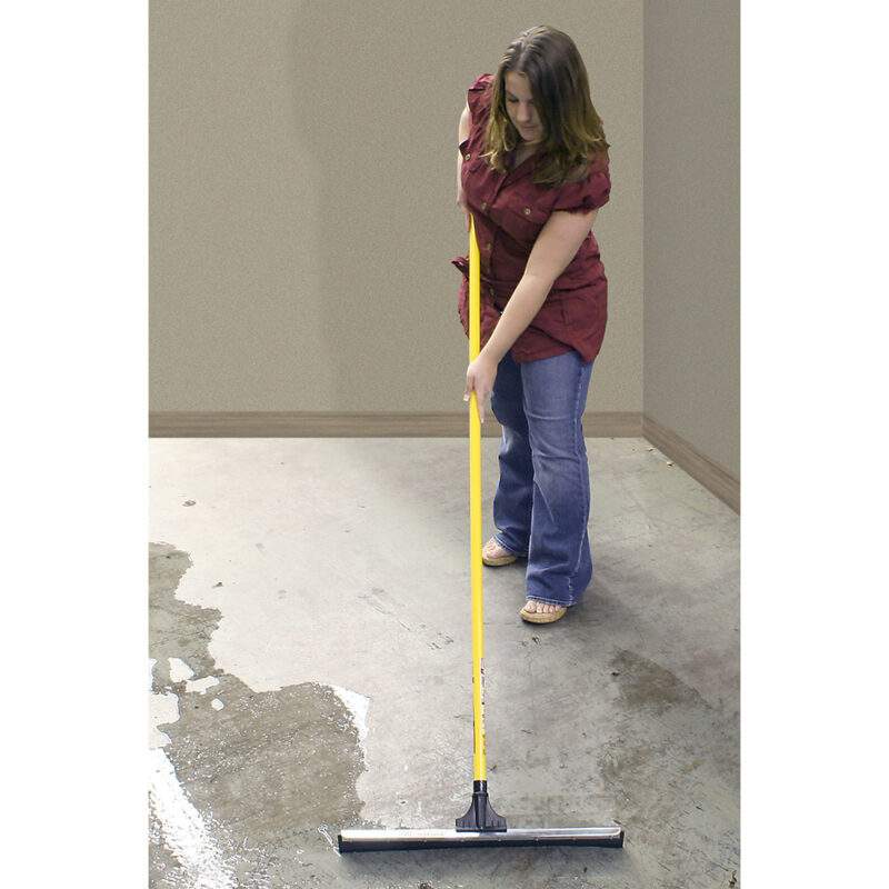 Fiberglass utility handle being used with a floor squeegee inside a garage