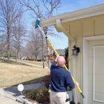 Cleaning gutters with the soft brush and Alumiglass extension pole