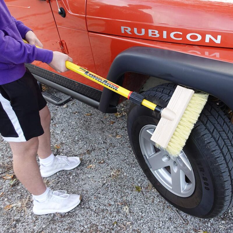 Closeup of stiff bi-level brush cleaning tires on a Jeep