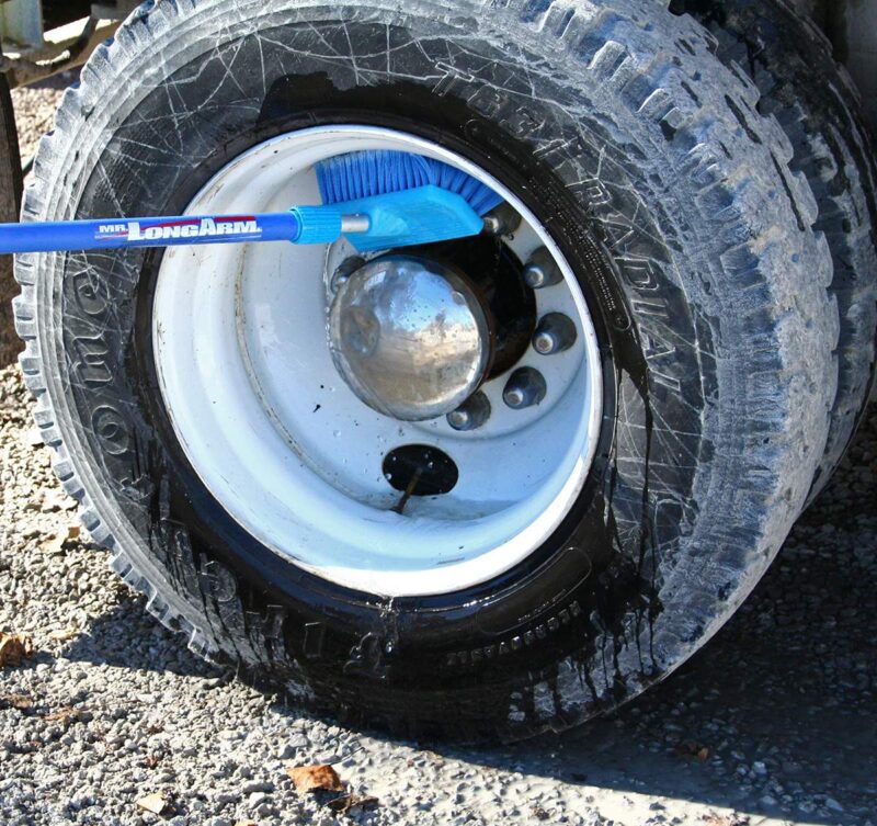 Brush cleaning wheel well