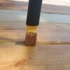 Woodmates Double-end Stain Applicator staining the gaps between boards