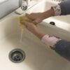 Rinsing the contour stain applicator pad before use.
