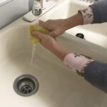 Rinsing the contour stain applicator pad before use.