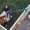 Flow-thru angle adaptor on a HydraSoar pole cleaning a gutter