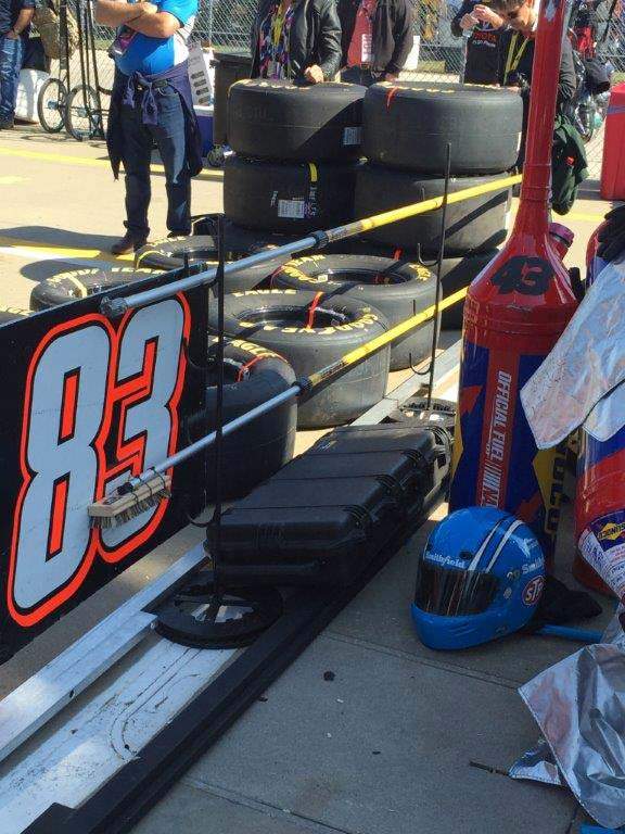 Nascar uses long poles to signal drivers into the pit.