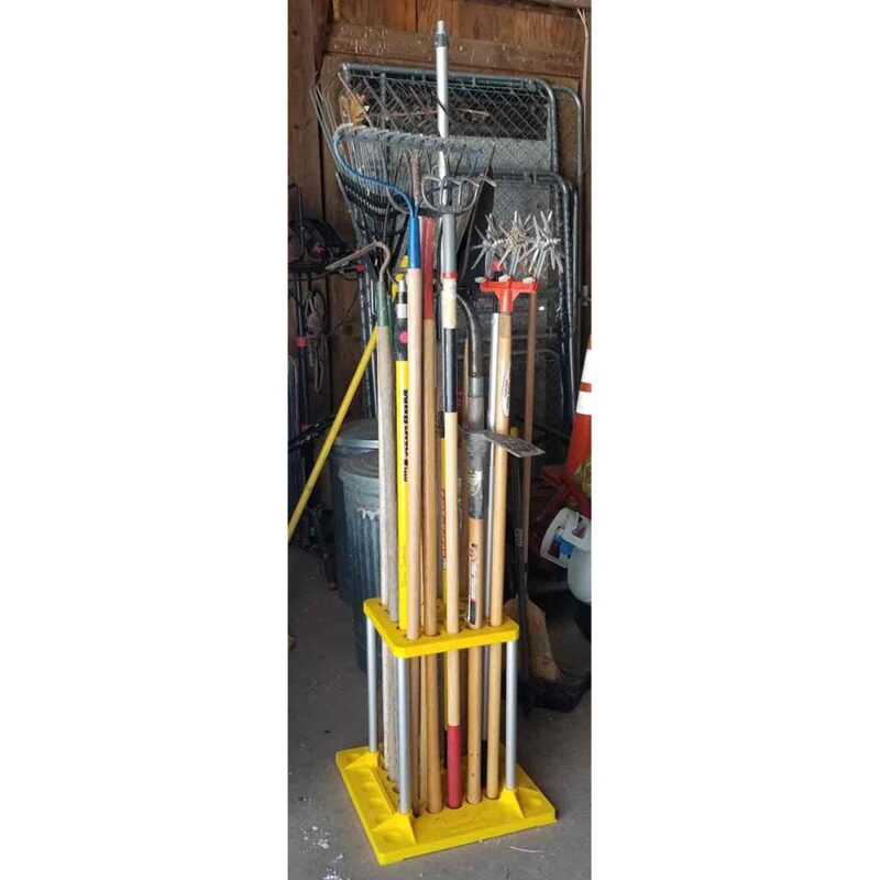 Yellow tool storage rack in use in a barn.
