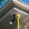 Closeup of complete light bulb changer kit changing an outdoor floodlight