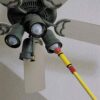 Closeup of classic light bulb changer changing bulbs in a ceiling fan
