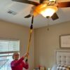 Dusting a ceiling fan with Alumiglass 3-6 ft extension pole.