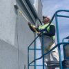 Contractor on a lift painting with a 2-4' Super Tab-Lok extension pole