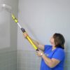 Woman painting a small bathroom wall using the 2-4' Super Tab-Lok
