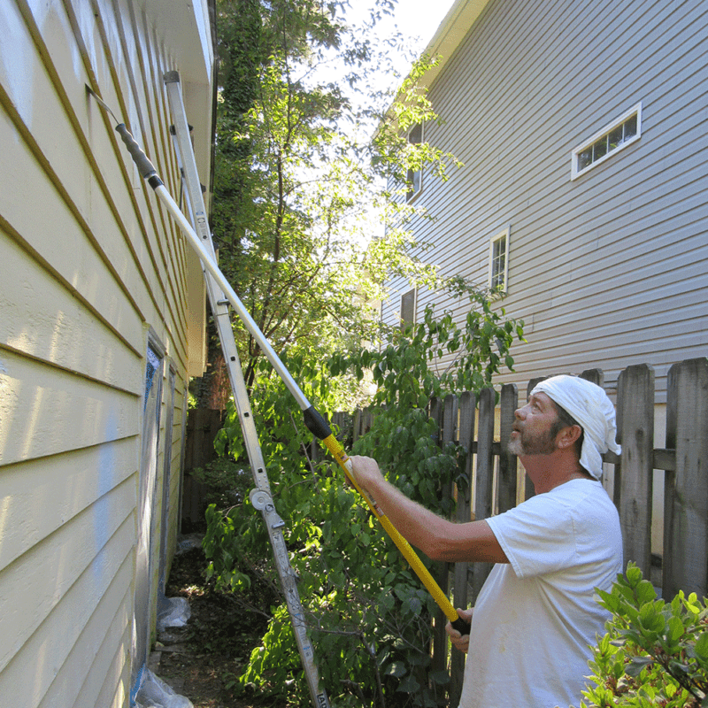 Scraping exterior siding with the Super Tab-Lok extension pole.