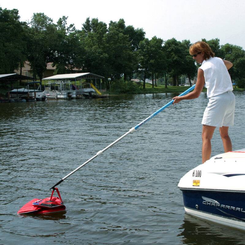 Using a hook to retrieve a life vest from the water